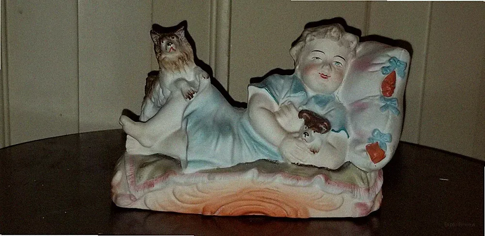 ANTIQUE VICTORIAN BISQUE FIGURINE OF CHILD RECLINING WITH DOGS